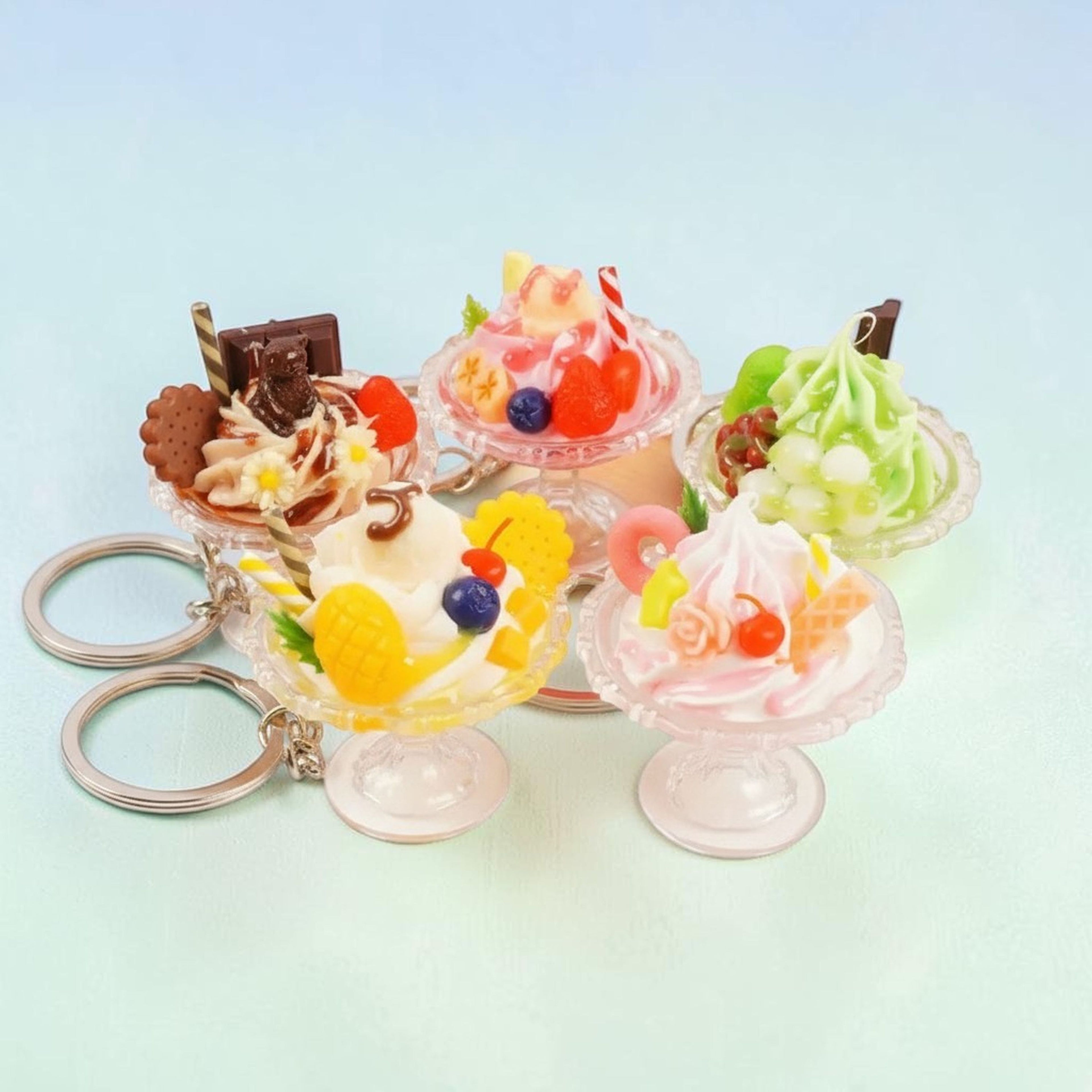 Kawaii mango ice cream sundae keychain with waffle cookie and blueberry on mint background