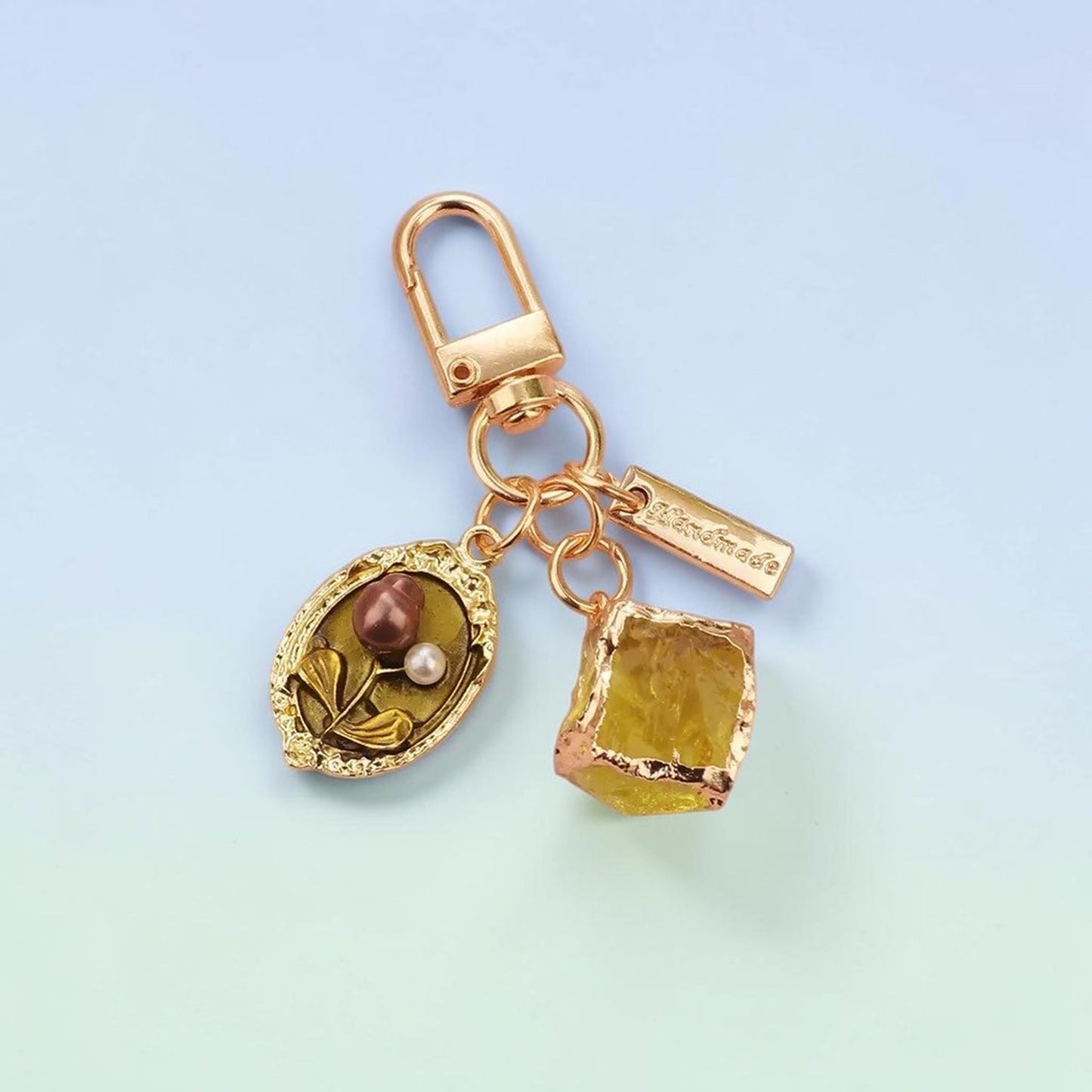 Olive green pearl frame charm keychain with pink resin gem