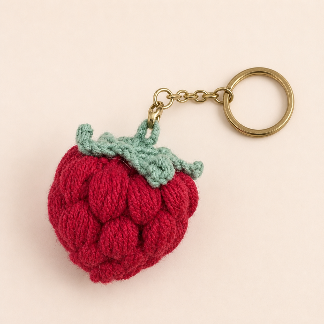 Strawberry crochet keychain with size dimensions - 5cm height, 4.6cm width