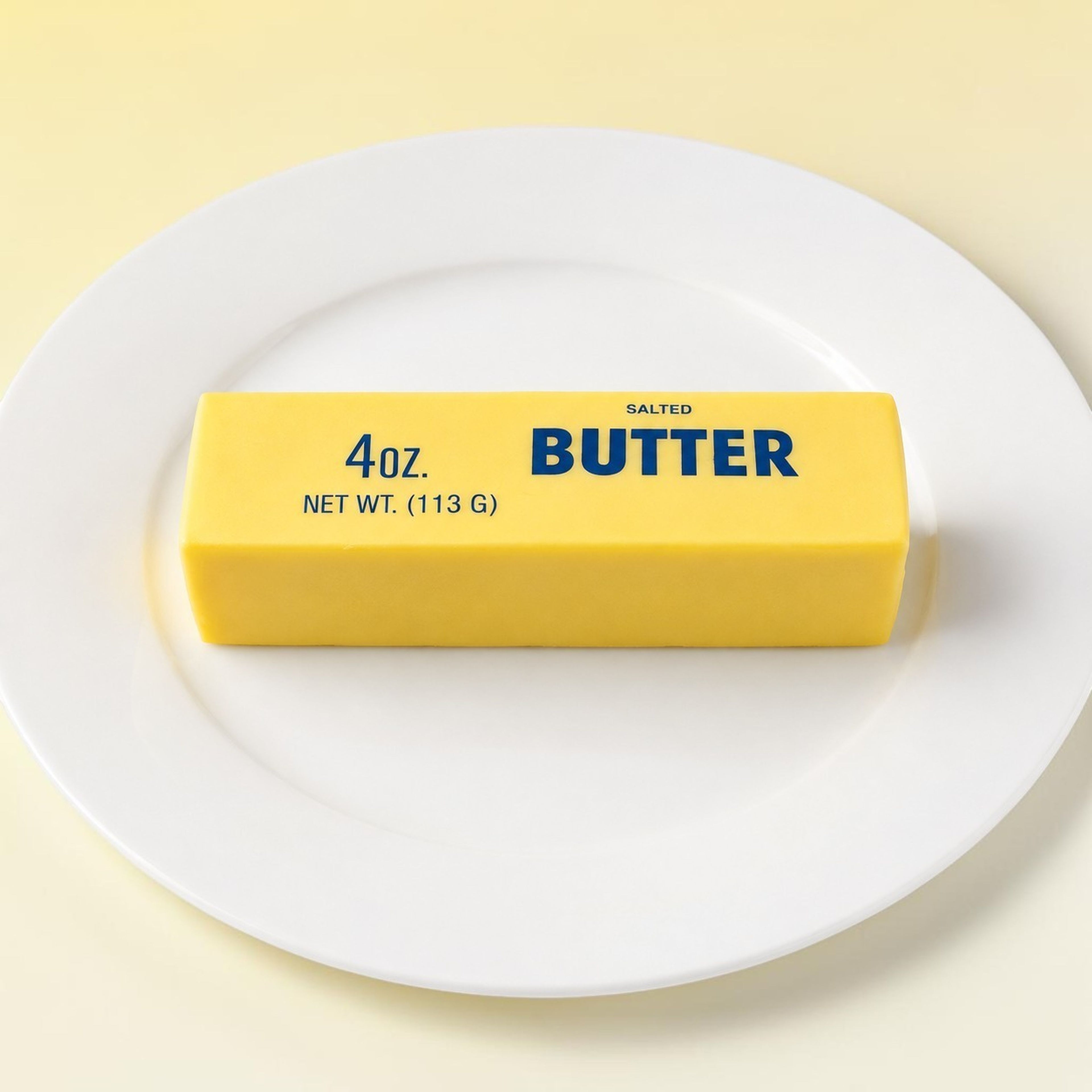 Butter squishy on white plate with yellow background