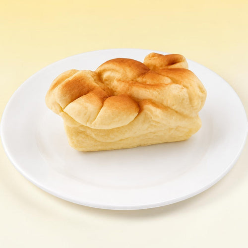 Bread loaf squishy toy on white plate with white background